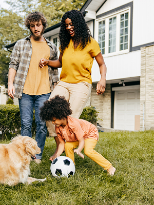 girl and dog playing soccer