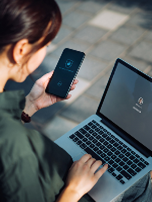Overlooking a girl on her phone and computer securing her devices