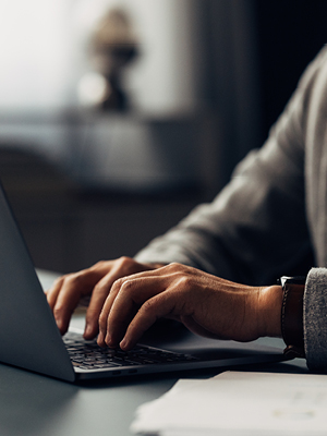 someone typing on a laptop computer