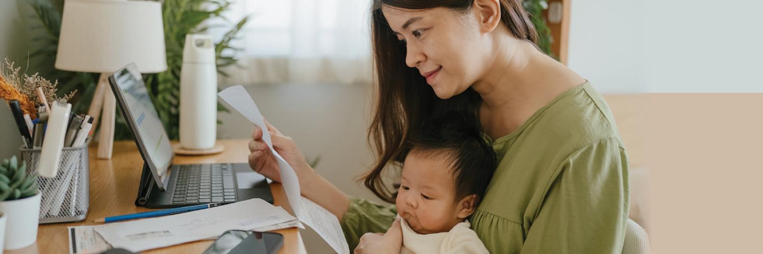mom and baby looking at a statement