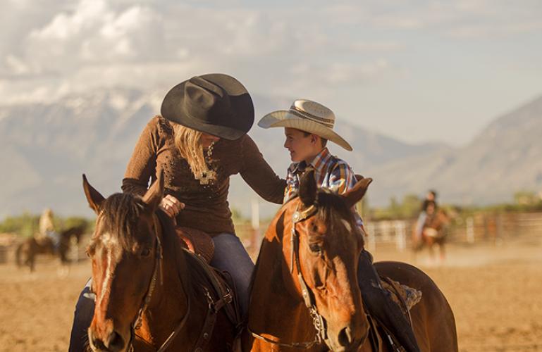 picture of a mom and son riding horses