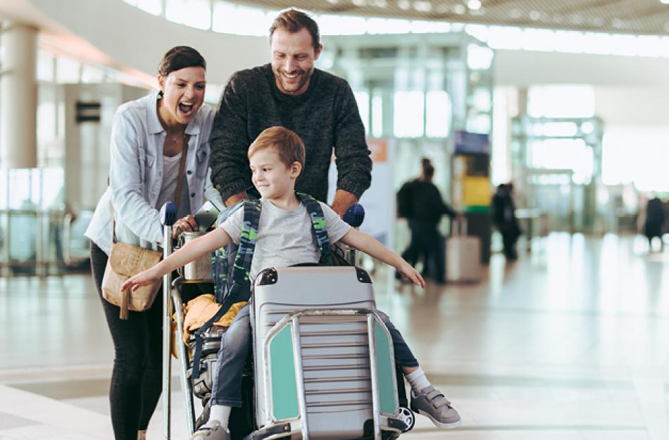 family pushing boy on a cart