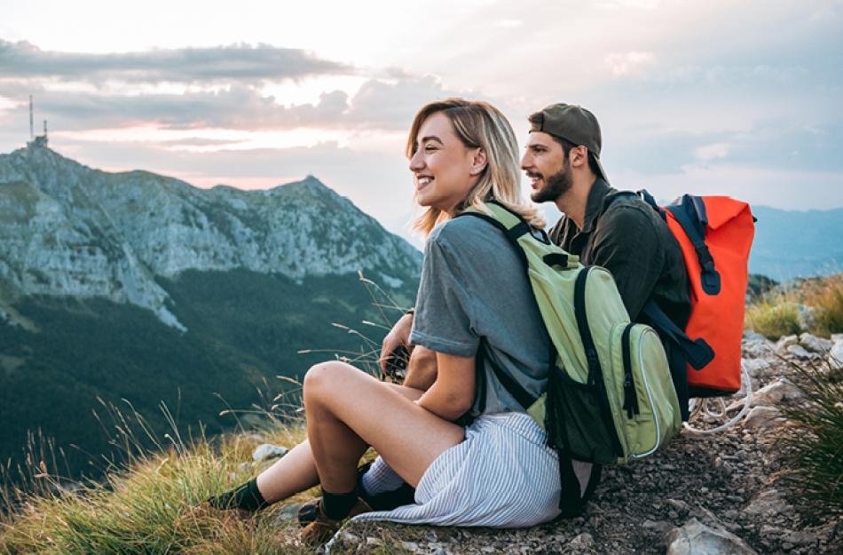 picture of a couple sitting on top of a mountain
