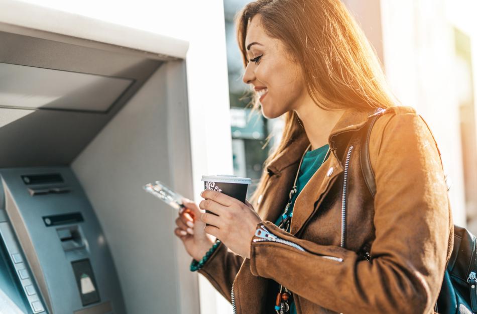 woman using ATM Live